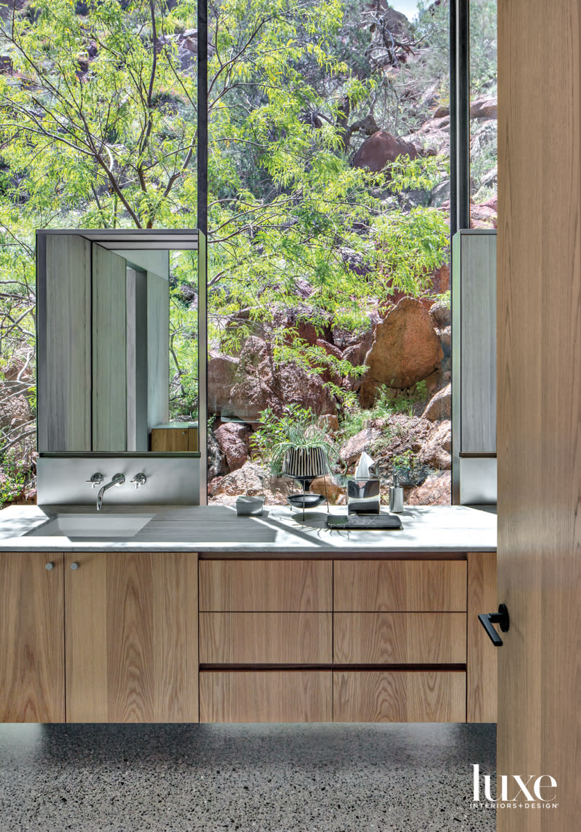 A bathroom vanity that looks directly out at the mountain.