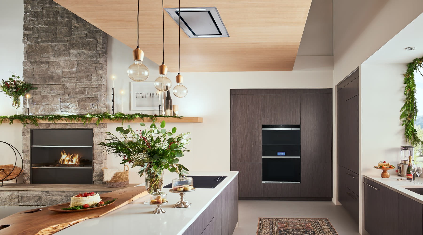 A spacious kitchen showcasing white cabinetry and rich wood flooring, blending elegance with comfort.