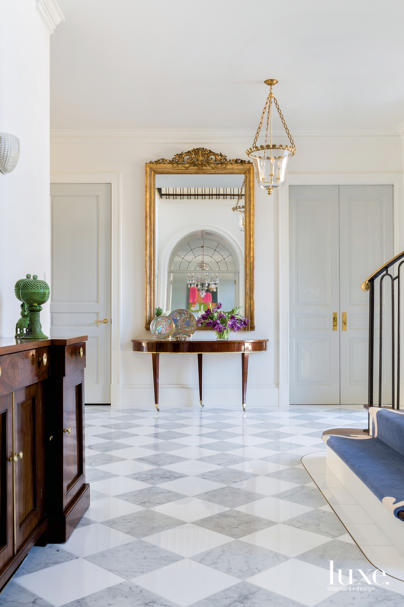 traditional foyer mirror gold accents marble flooring