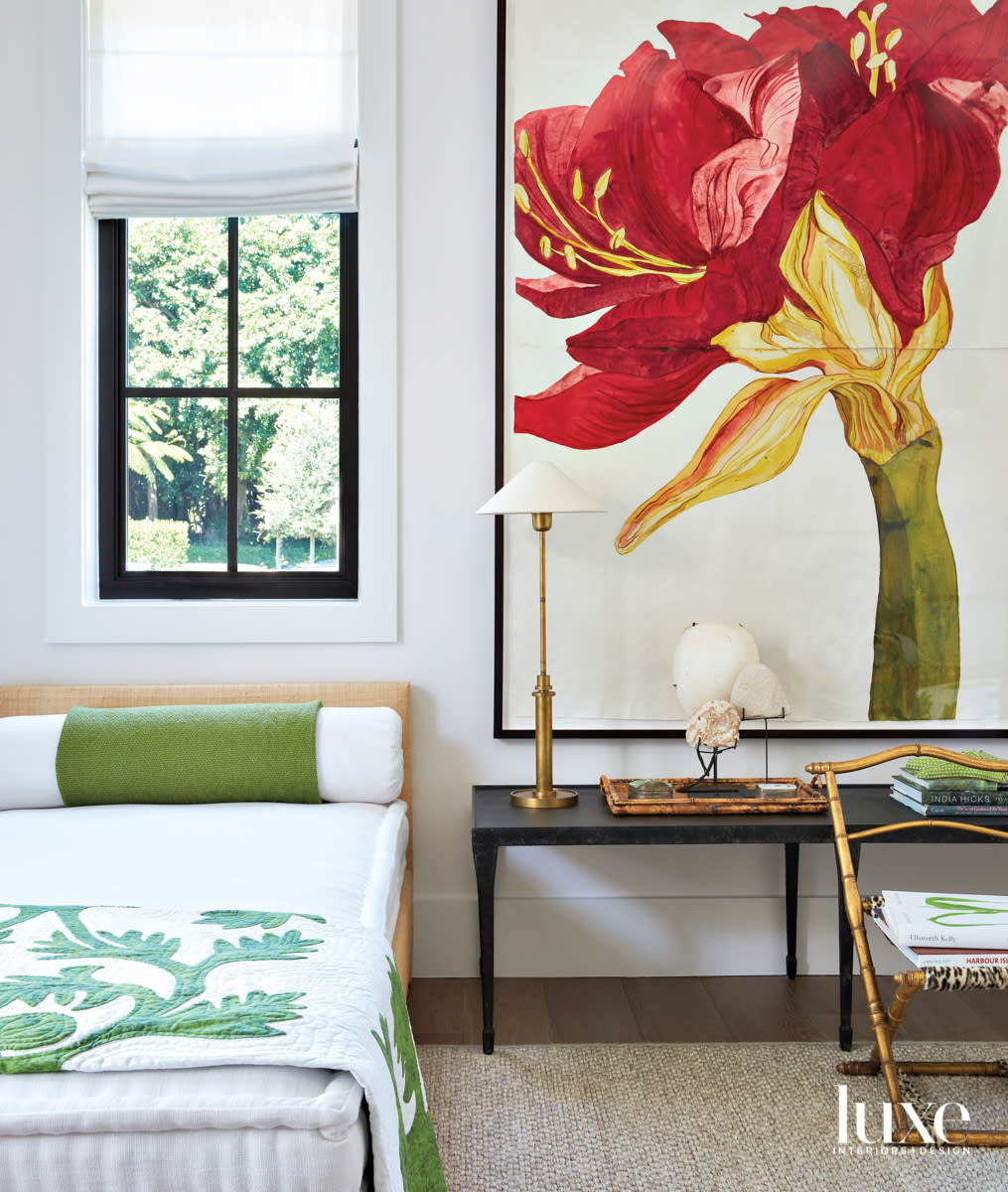 guest bedroom with twin rattan beds, red amaryllis artwork and green bedding