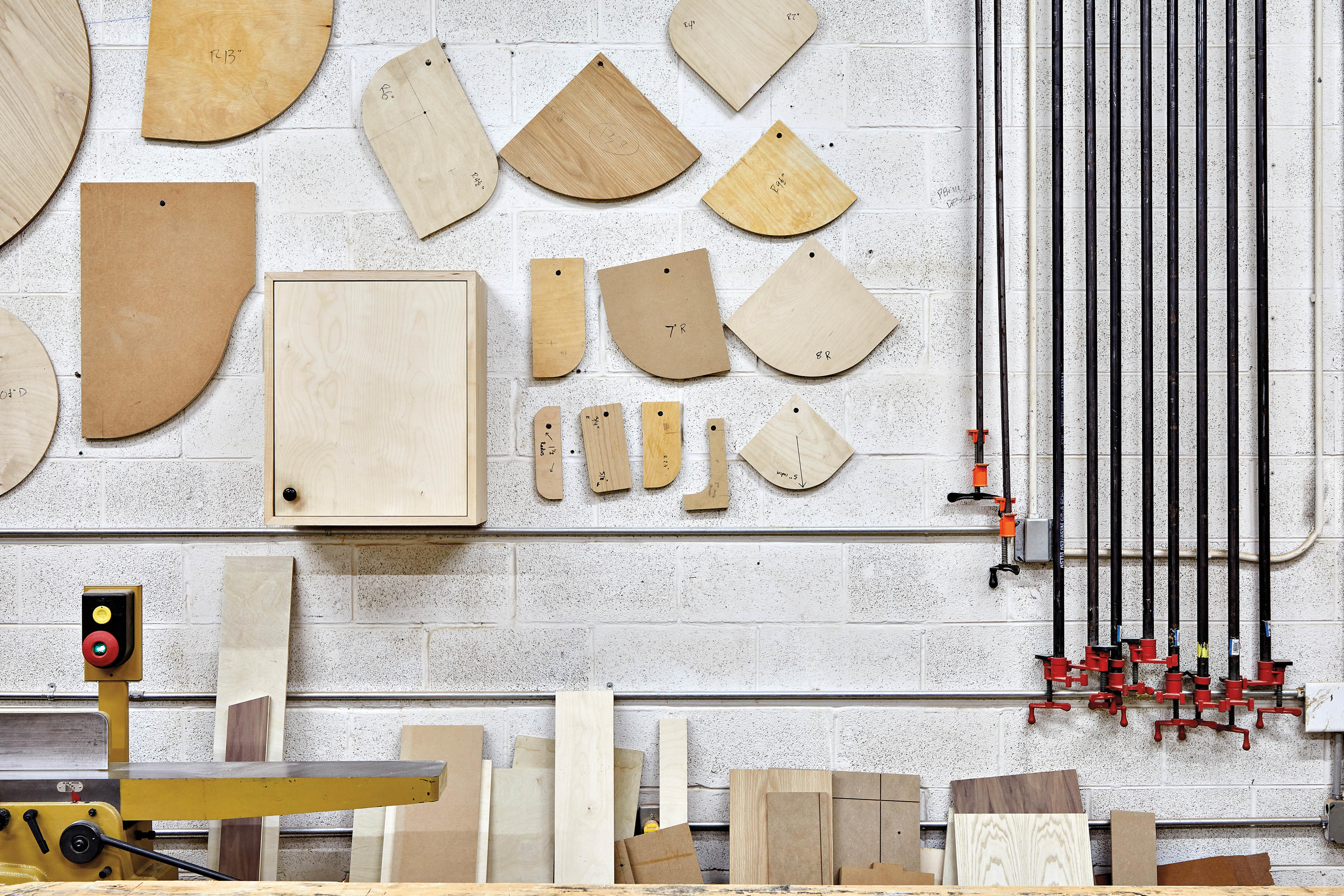 wood samples hanging on the wall of a woodworking studio