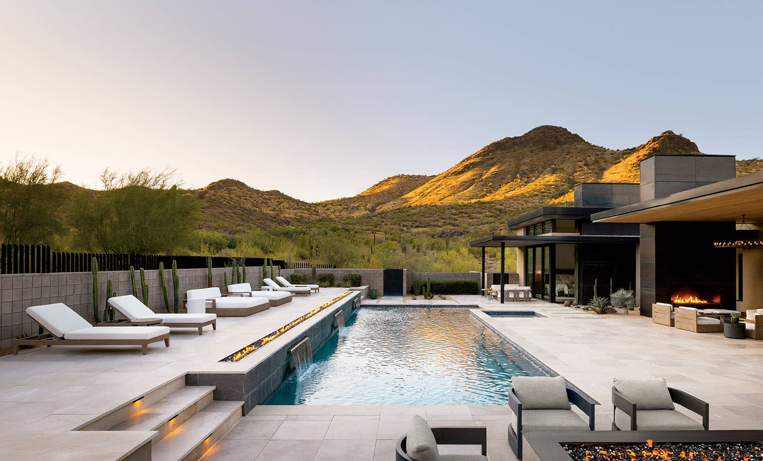 contemporary pool deck of an Arizona home with views of the desert landscape beyond