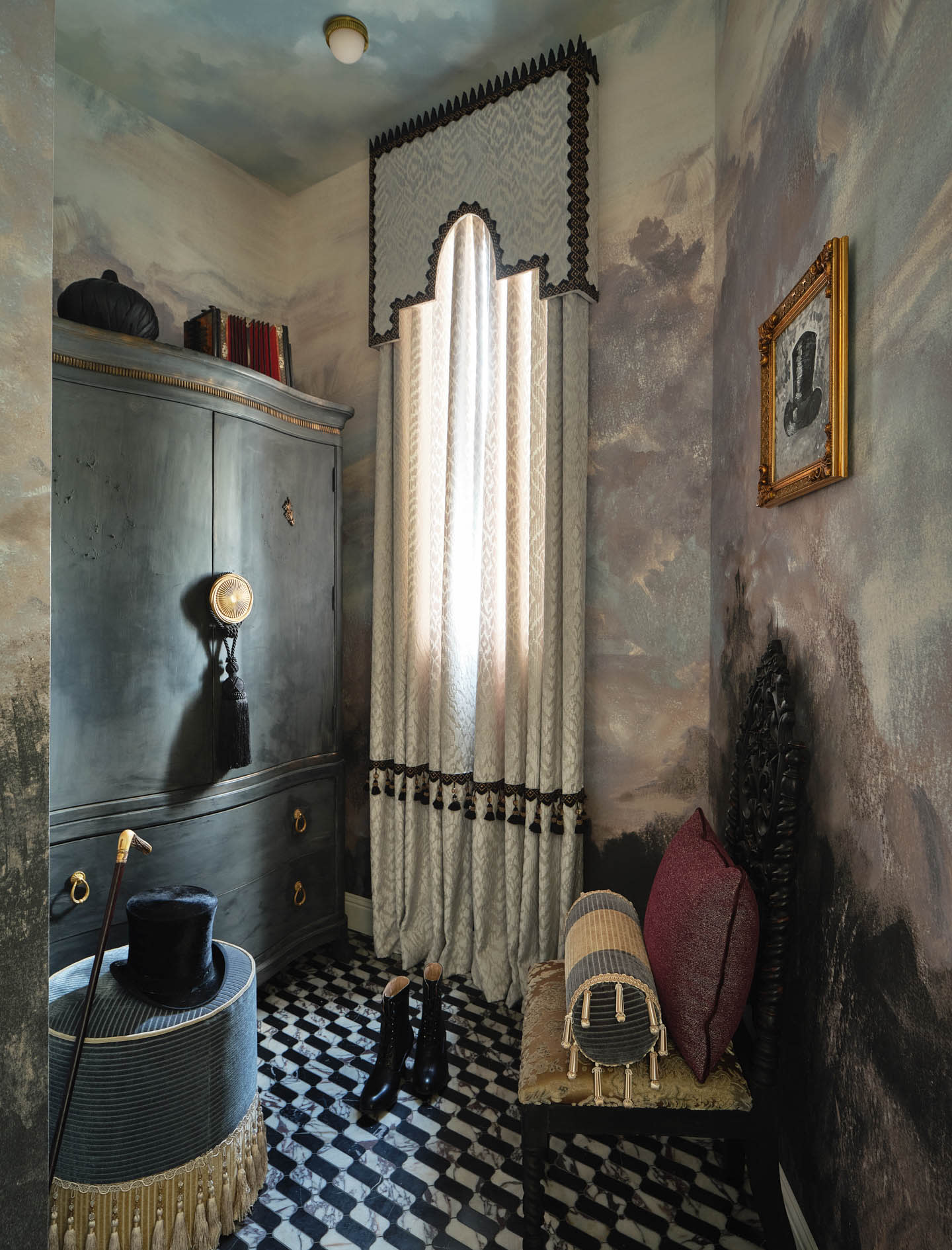 A vintage room with a dramatic, moody atmosphere. Features a textured wardrobe, ornate curtain, checkered floor, elegant hat, boots, and framed art.