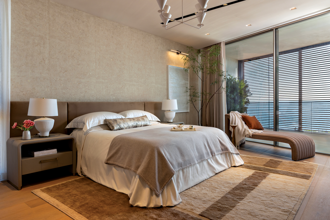 The primary bedroom features Frette’s Ultimate bedding set over Cortina fillers, with a Double Cashmere blanket, Pure Cashmere throw blanket and Luxury Passepartout throw pillow