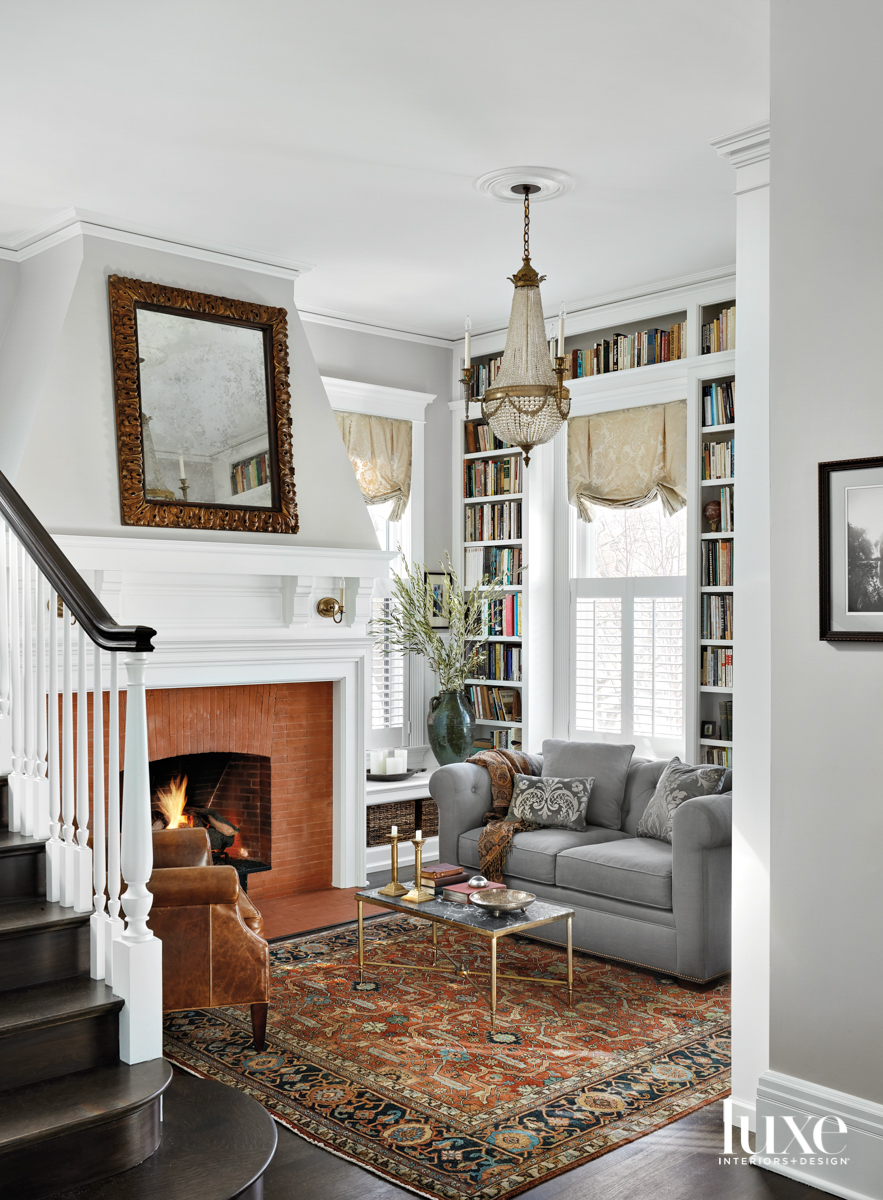 A library with a brick fireplace.