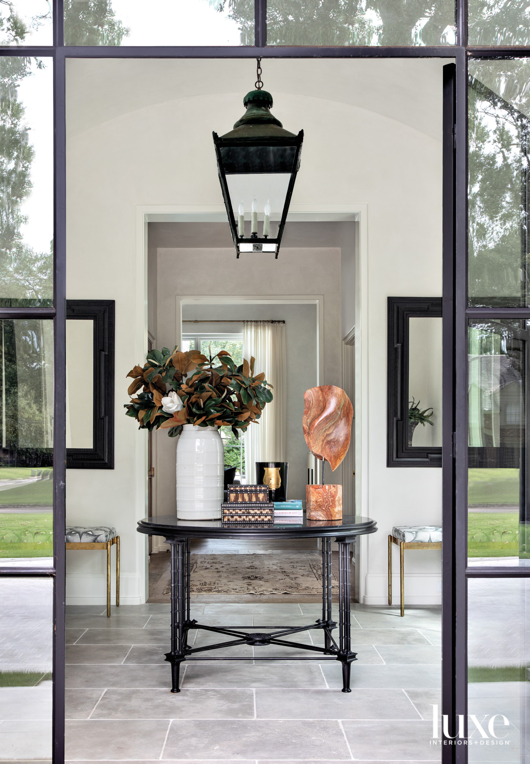 View of entry space featuring a center table and hanging lantern