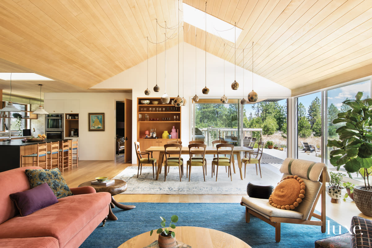 Combination living room, dining room and kitchen with wood paneled ceiling