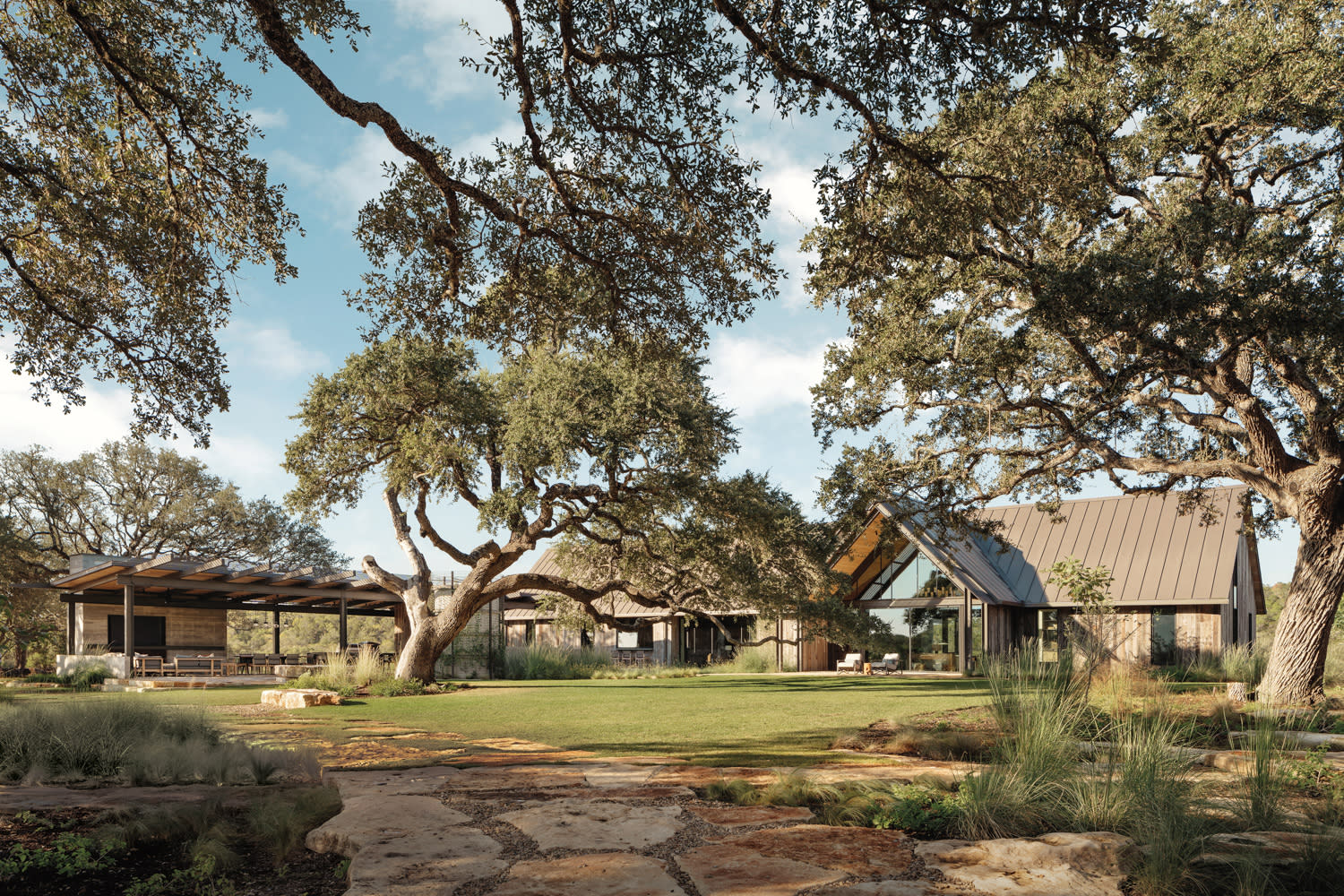 exterior of a traditional home behind large trees