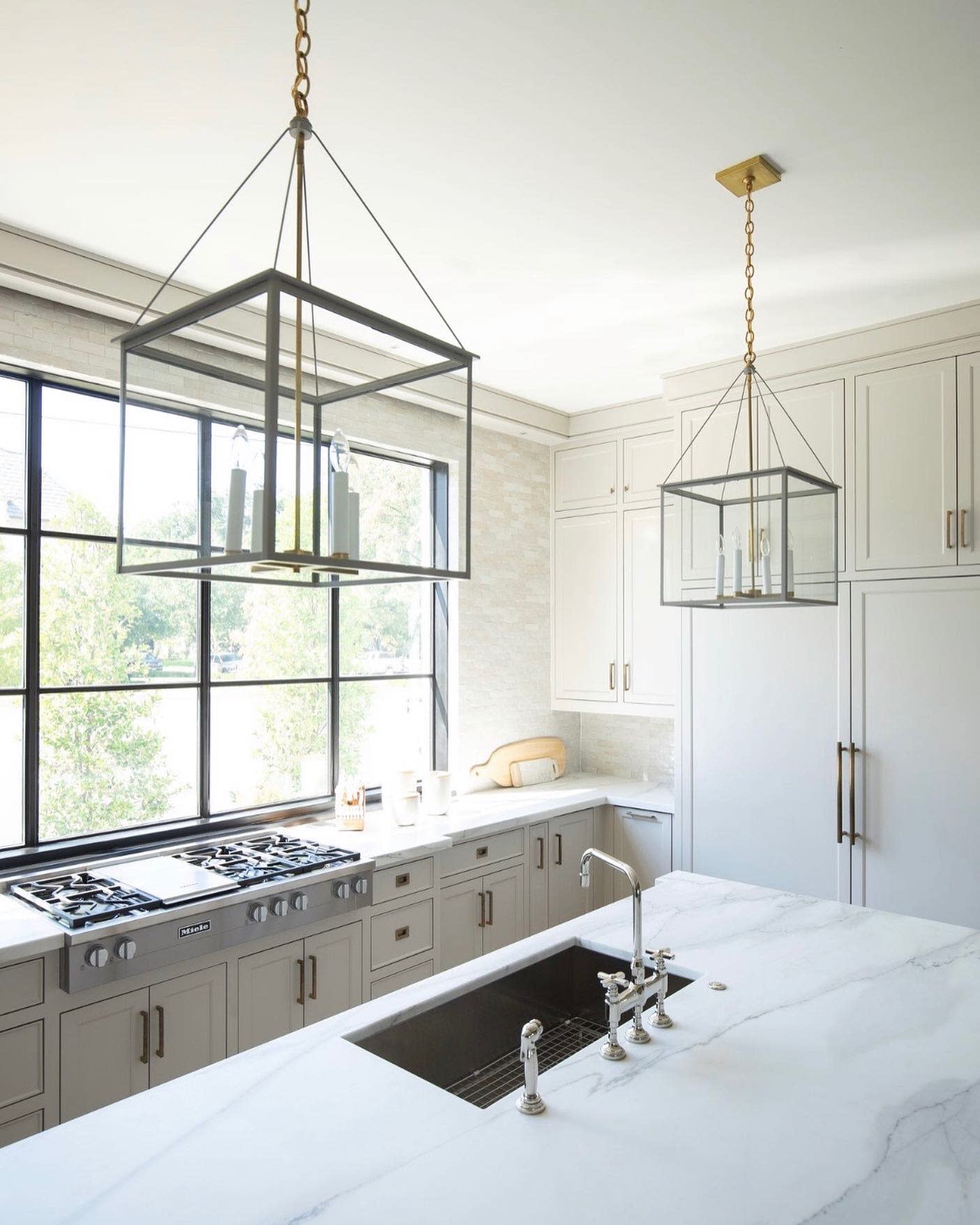 kitchen island view with big windows and pendant lighting