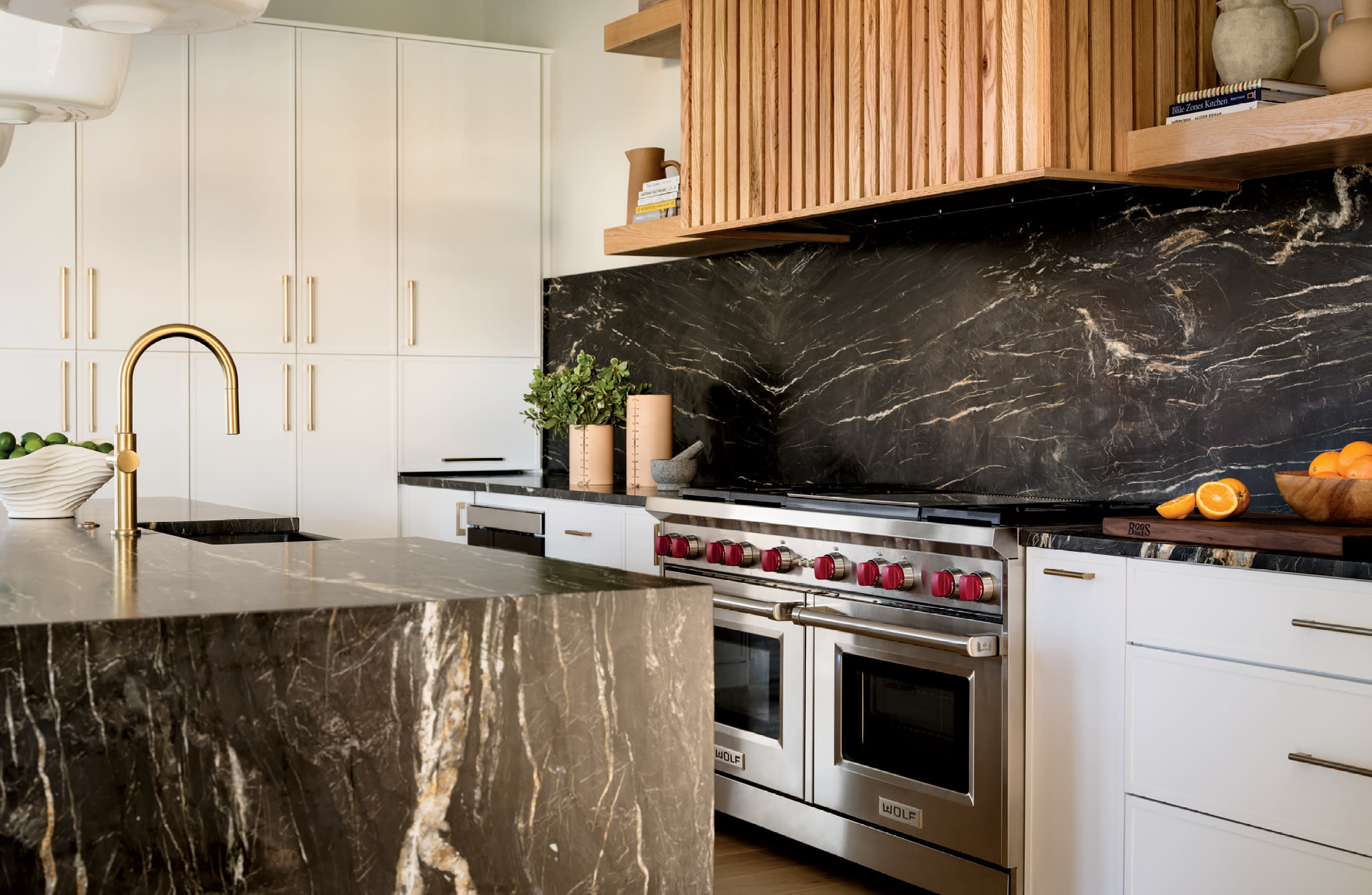 black marble backsplash in a modern kitchen with a matching marble island