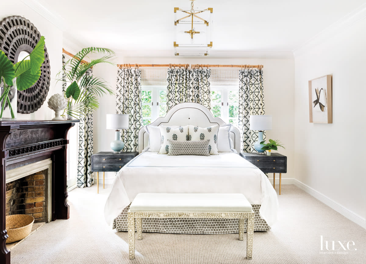 bedroom with black and white bed and draperies