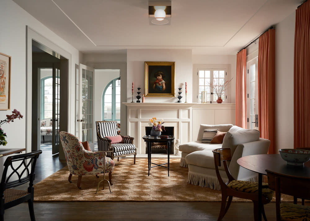 An elegant and formal living room receives some punchy accents of pink, floral and stripes to give a modern twist to this traditional space.