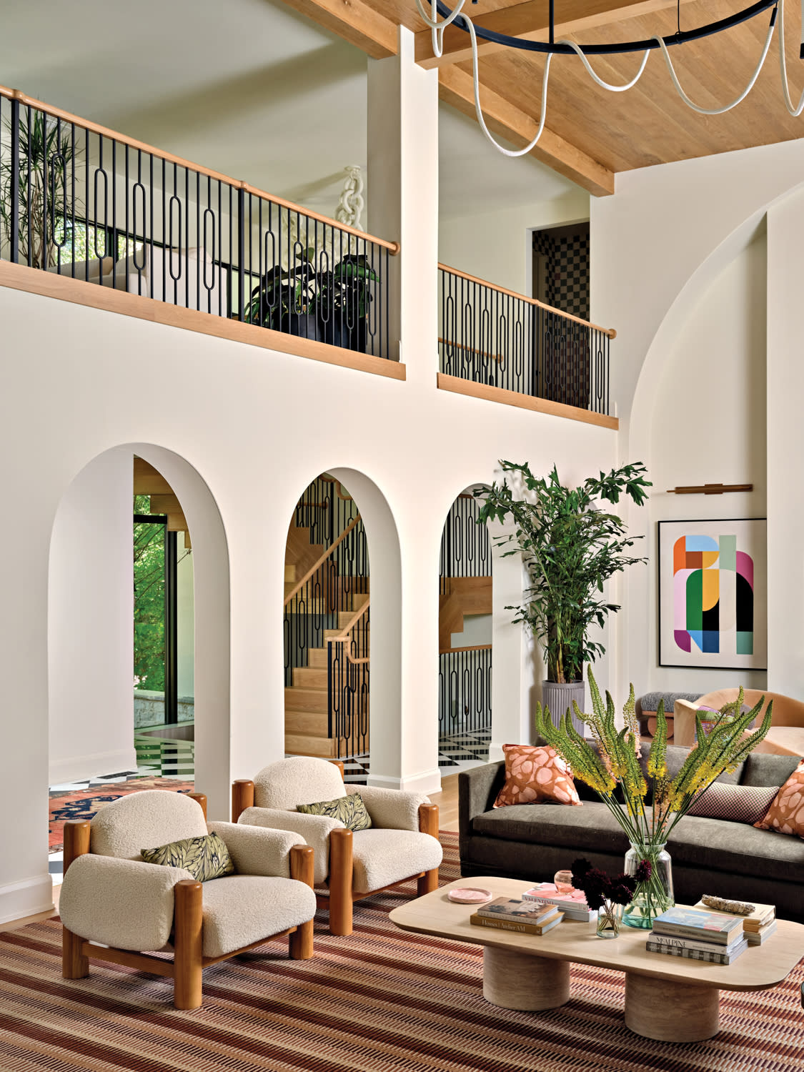 grand great room with colorful accents and three arched doorways
