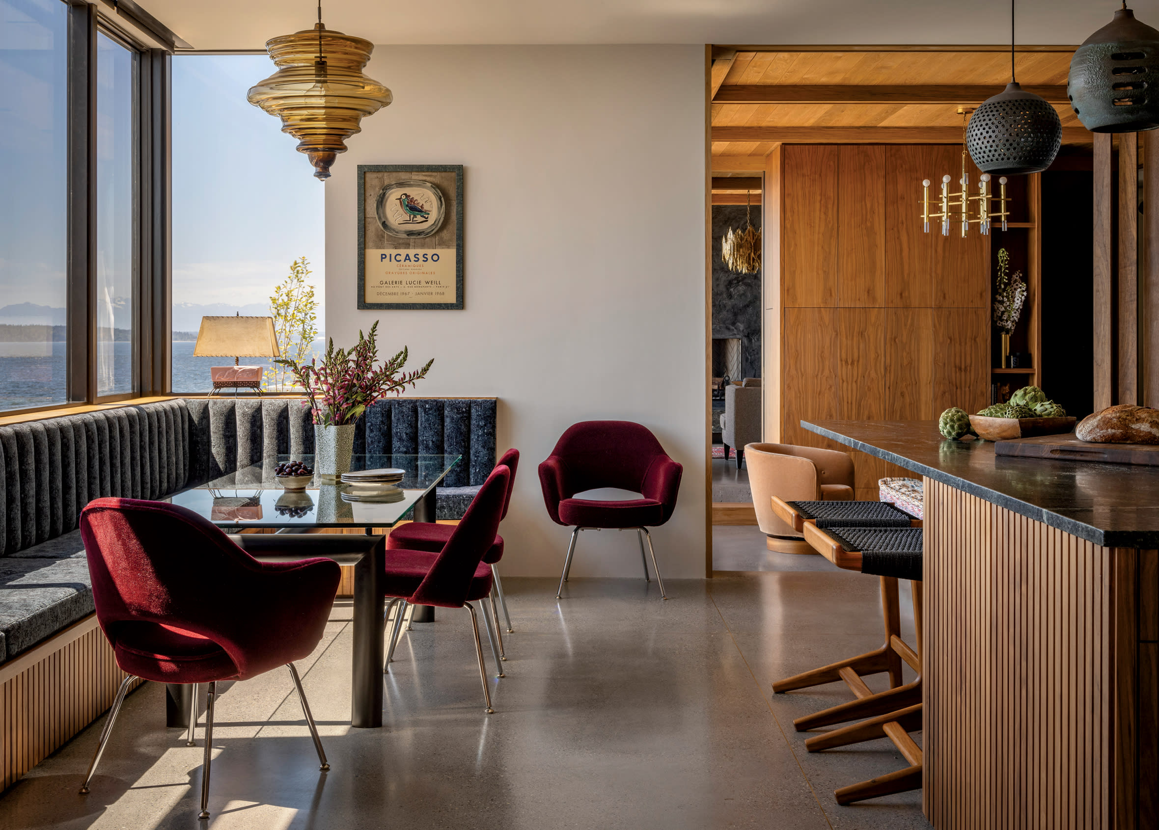 moody kitchen with red velvet chairs and a black banquette seat