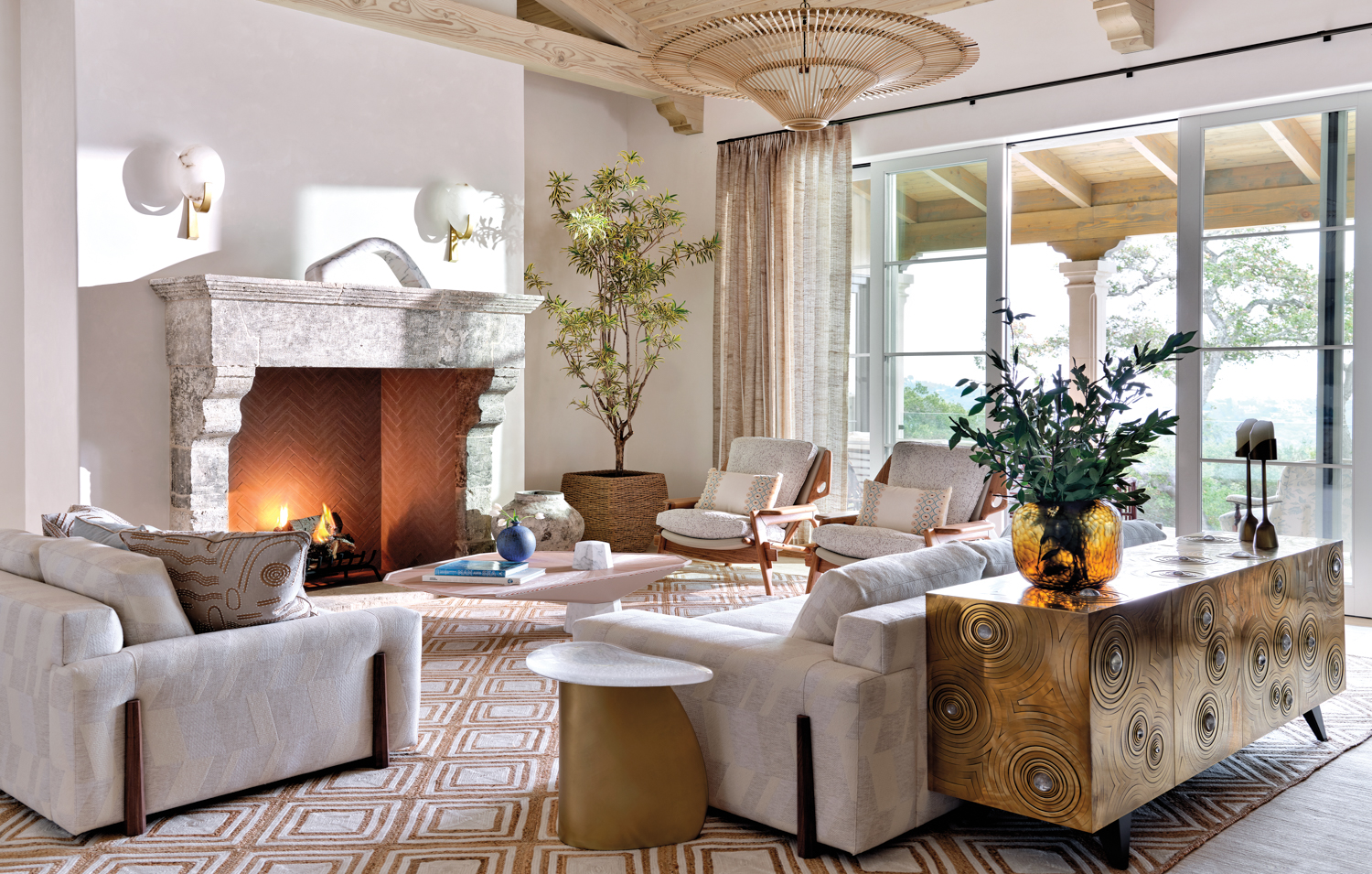 living room with fireplace, a gold sideboard and antique rattan light fixture by Penny Drue Baird