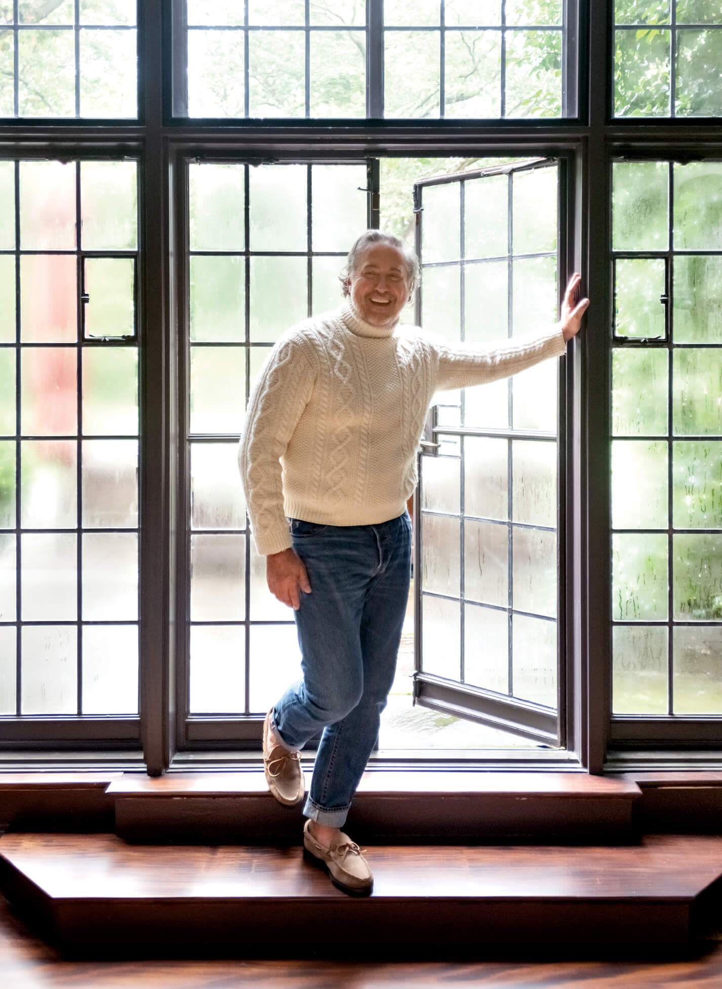 alfredo paredes in front of steel frame windows