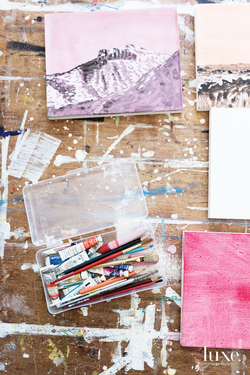 Bumiller reviews a vertical strip of watercolor studies for her Monumental series, which includes the partially finished work Tonto National Monument.