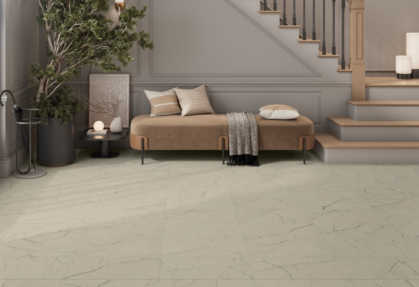 A modern living area with beige walls and matching marble floor. A cozy bench with cushions and a throw sits by a staircase. A large potted plant adds greenery.