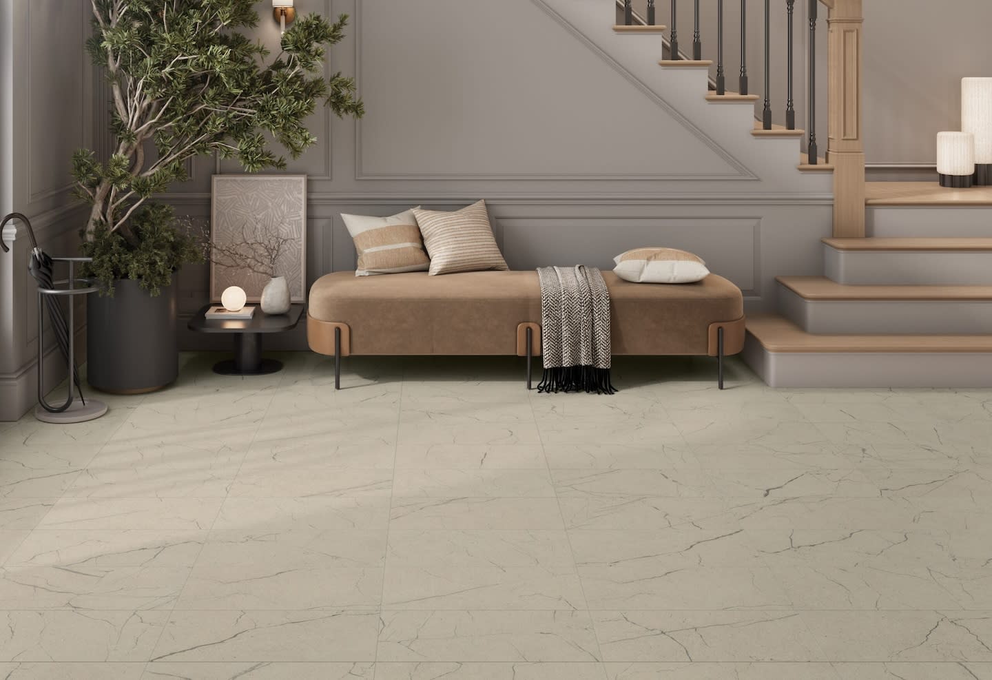 A modern living area with beige walls and matching marble floor. A cozy bench with cushions and a throw sits by a staircase. A large potted plant adds greenery.