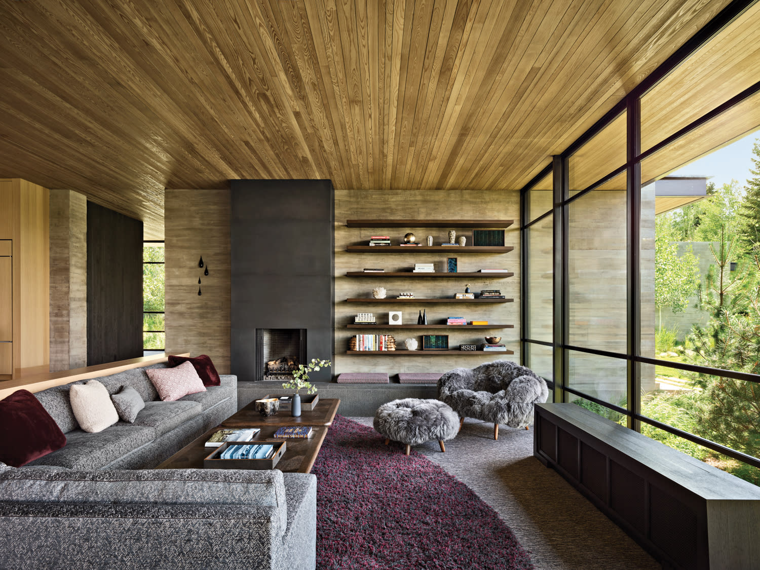 family room with wood walls and a grey sectional