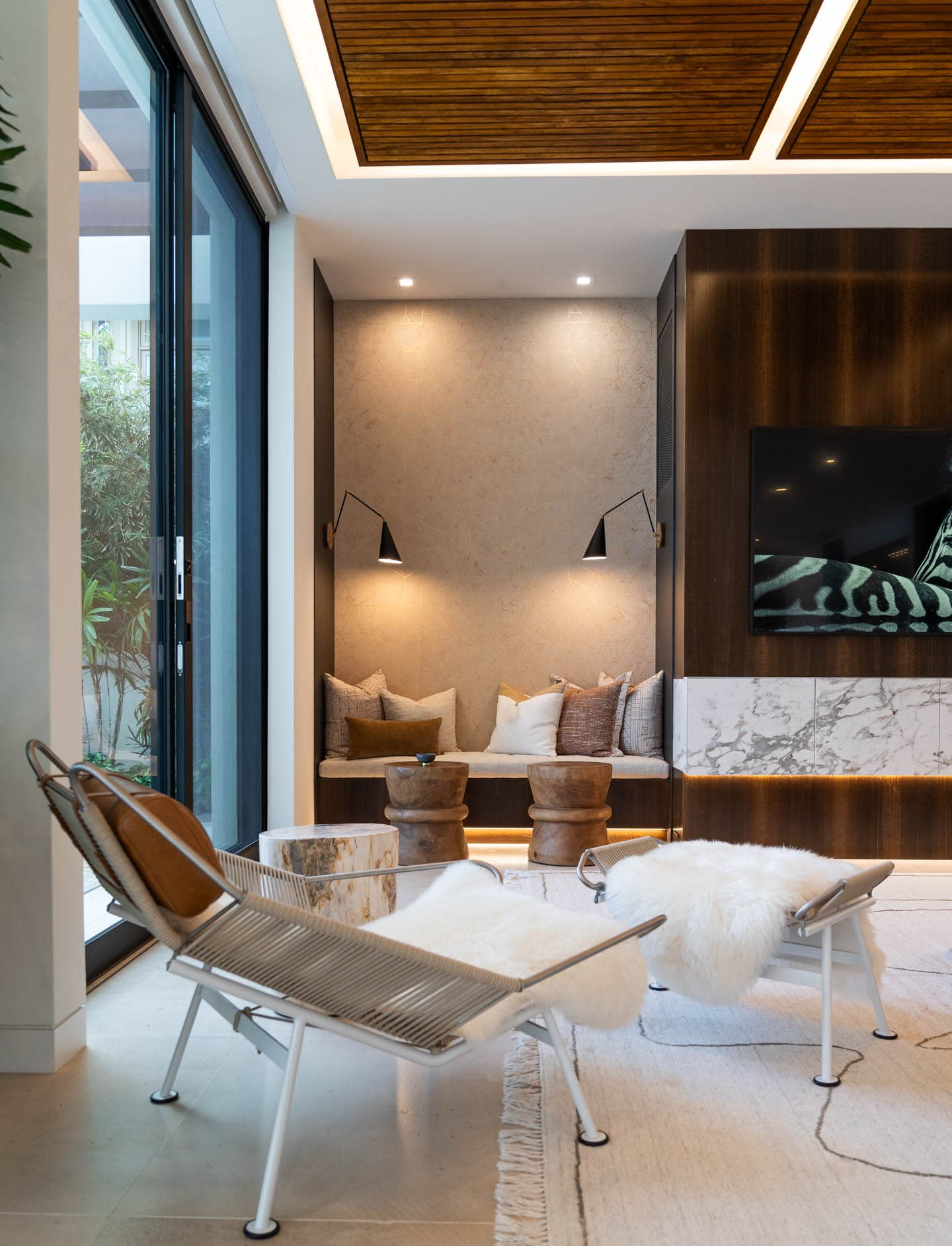 contemporary living room with architectural lighting and a cozy reading niche