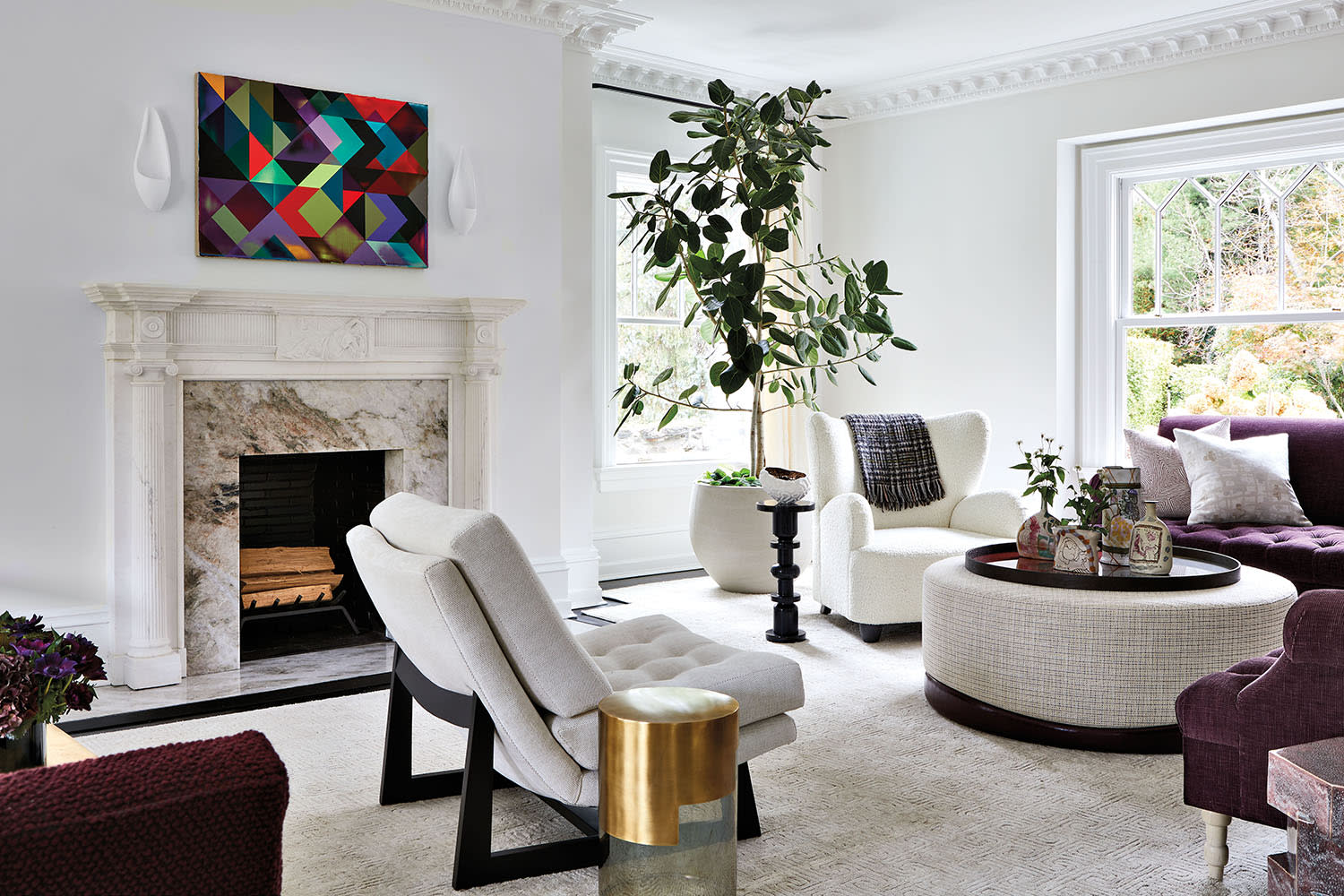 elegant, contemporary living room with a fireplace and white modern furnishings
