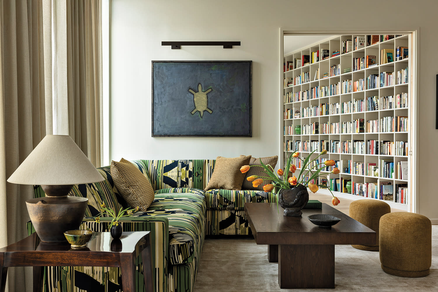 living room with midcentury pieces and a graphic print on the sectional