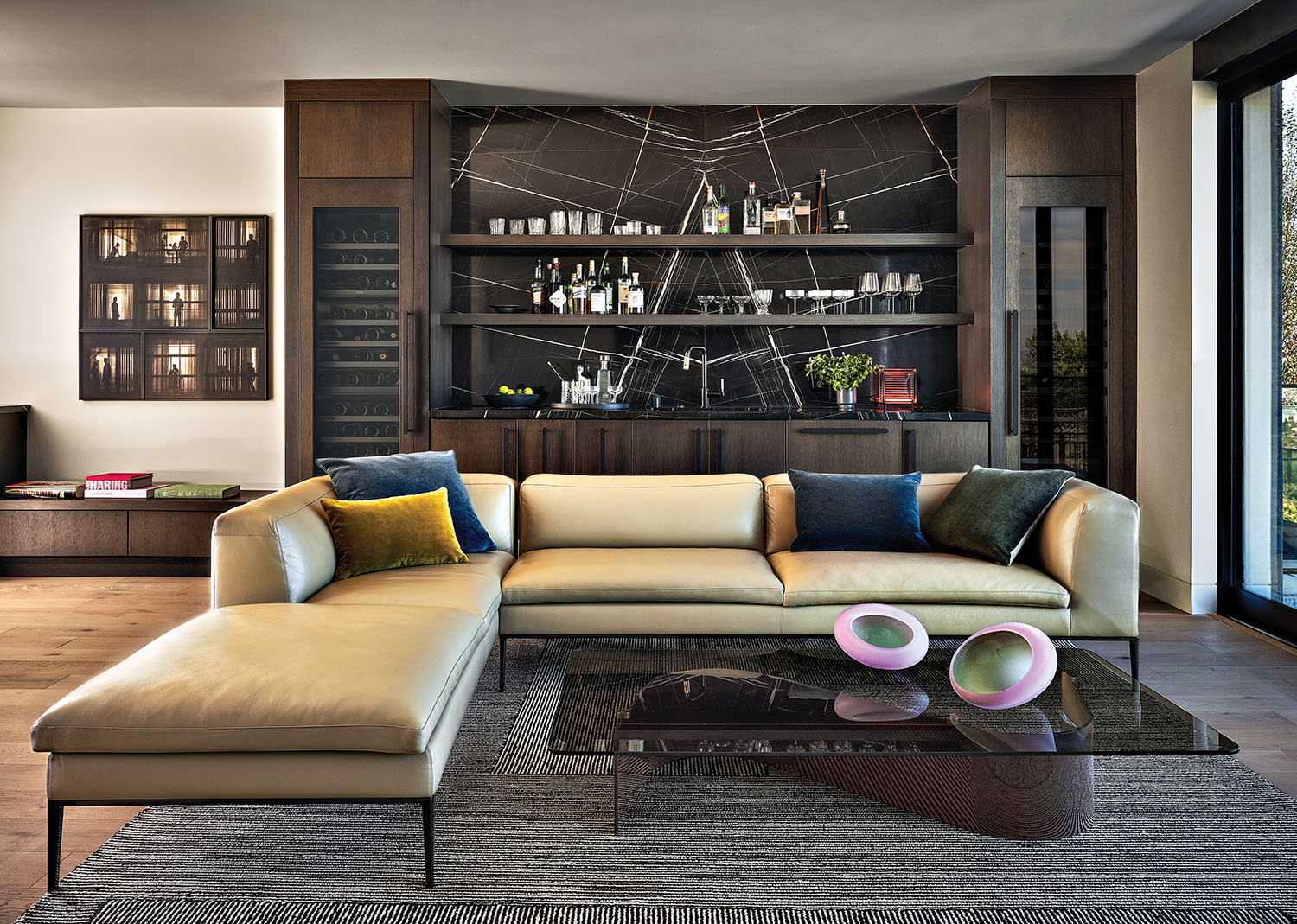modern lounge with a sectional in front of a wet bar