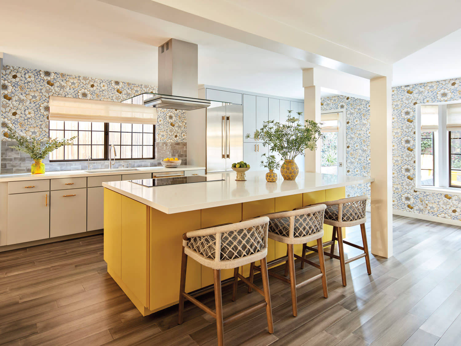 contemporary kitchen with floral wallcovering and a yellow island