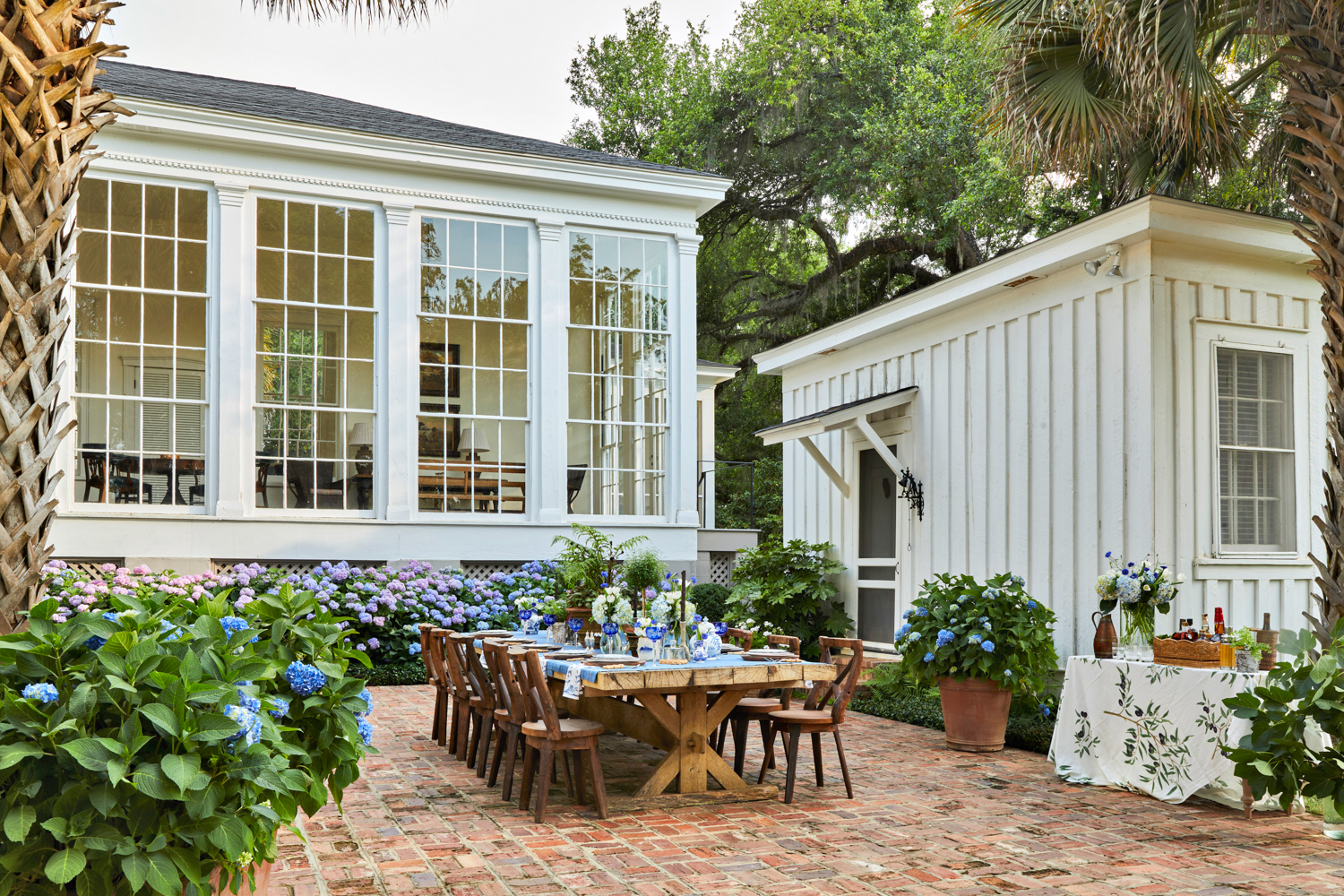 outdoor brick patio surrounded by hydrangeas