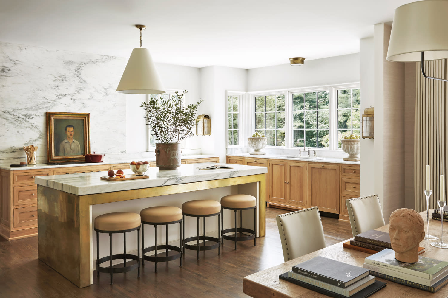 White kitchen with brass island and light brown accents