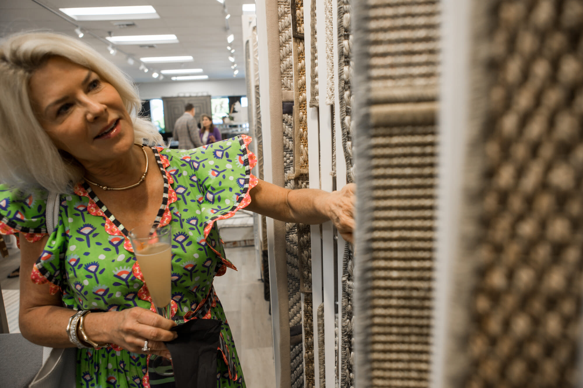 a lady looking at rugs