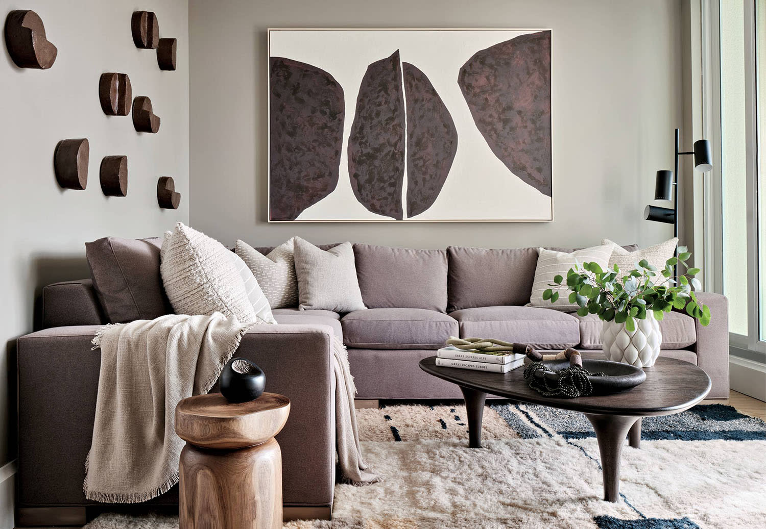 contemporary den with a plaster wall installation and a Thom Filicia artwork