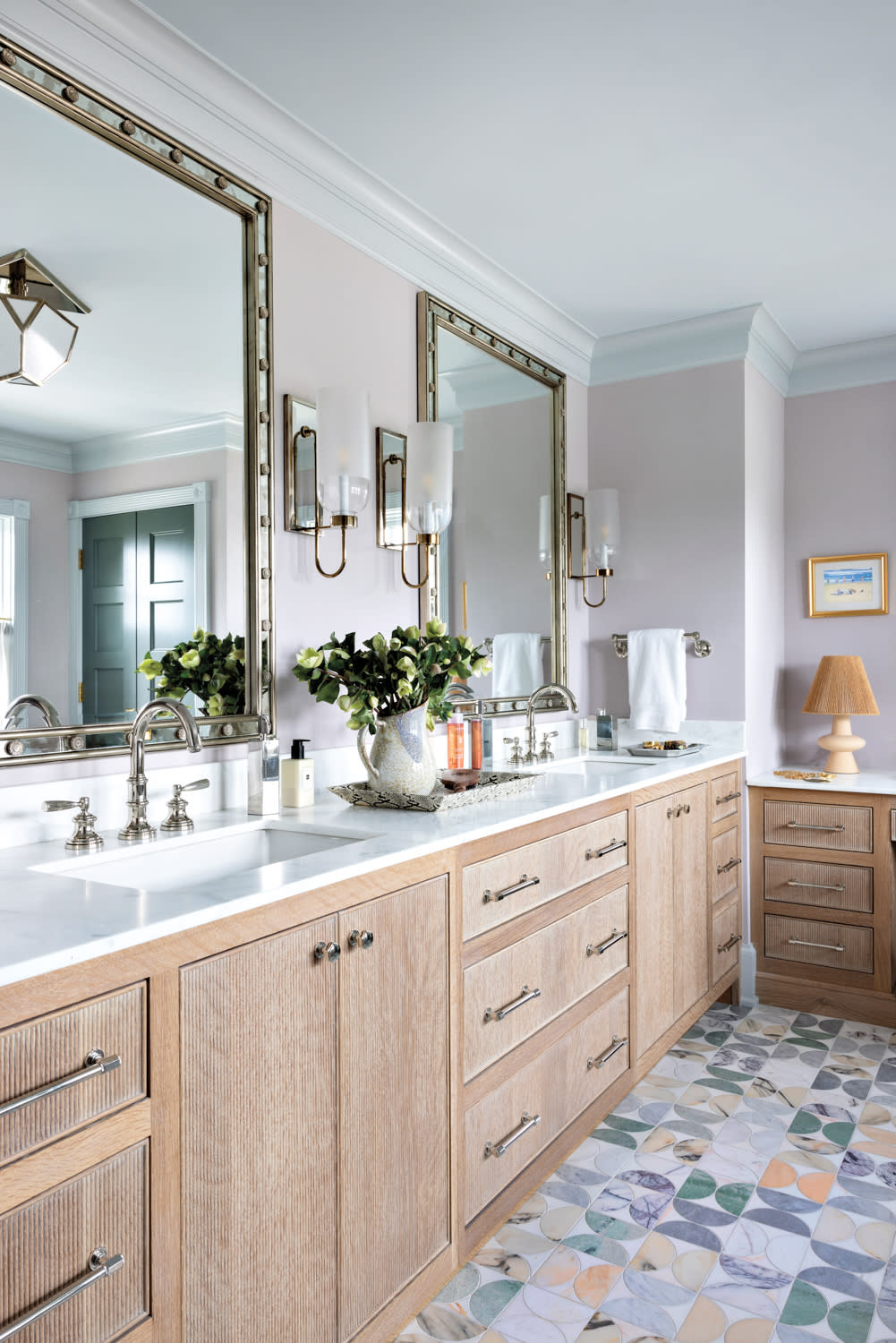 bathroom with a light wood vanity and colorful stone tile floor