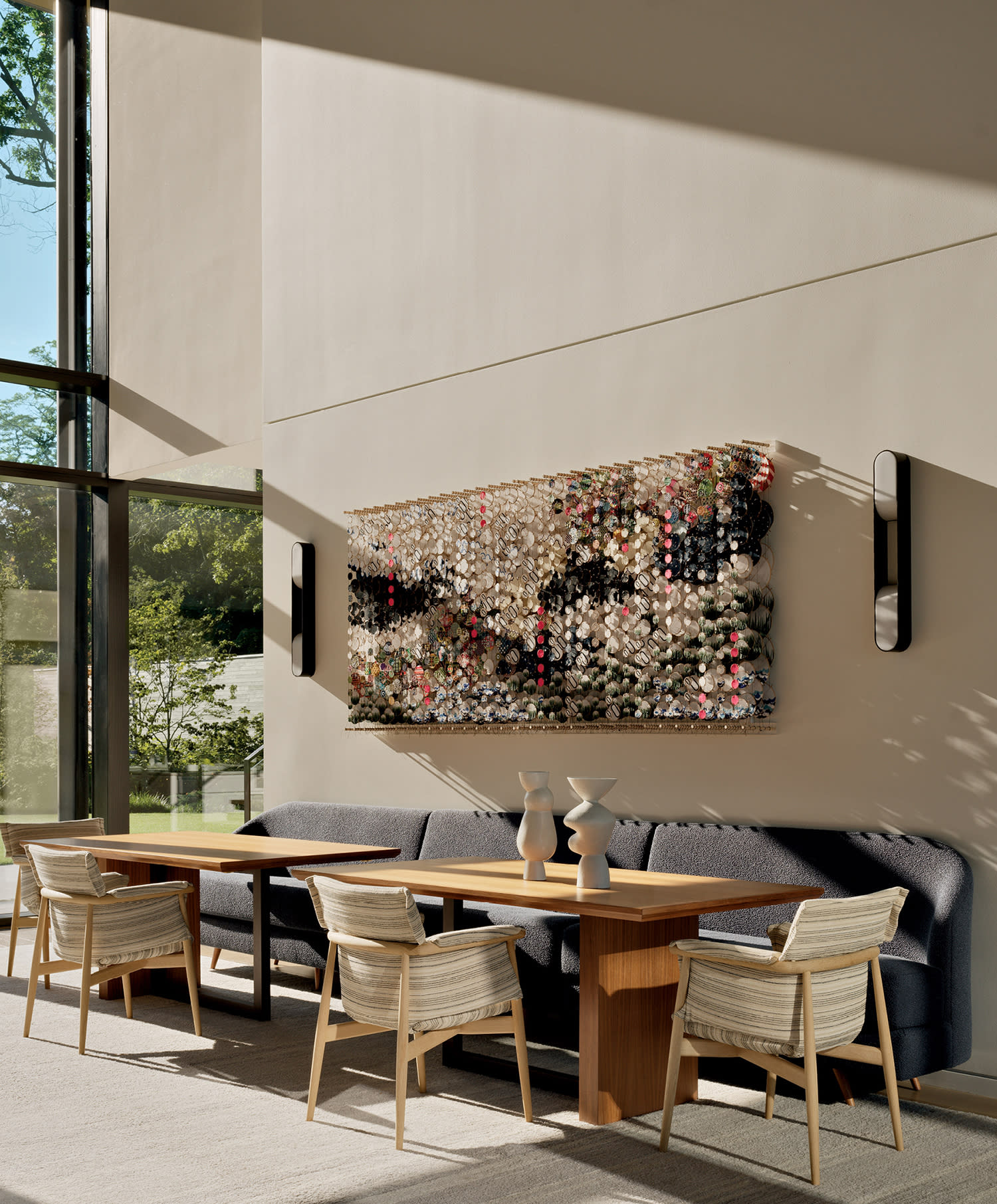 contemporary dining area with a Jacob Hashimoto artwork above