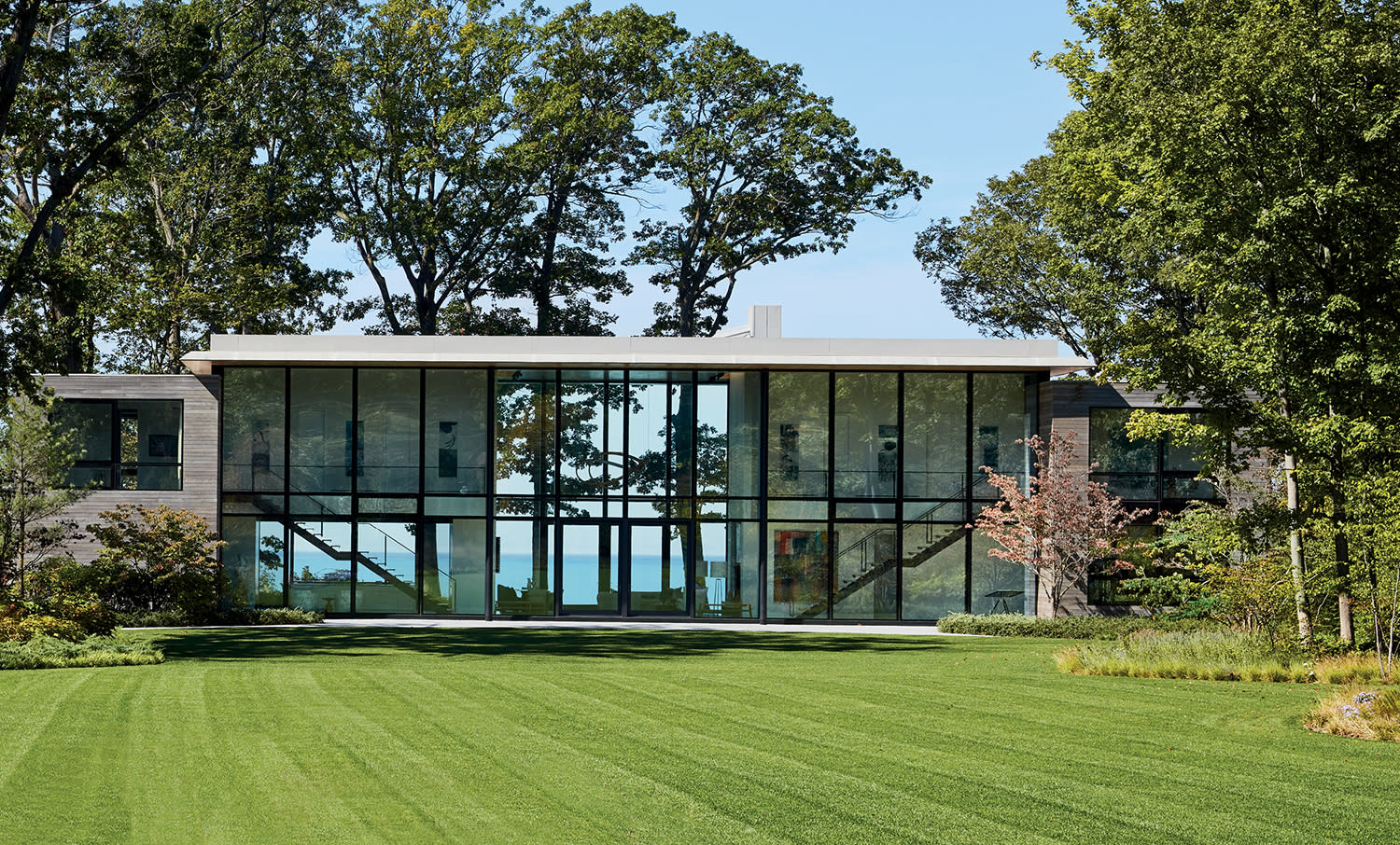 exterior of a modern glass-walled home in Michigan