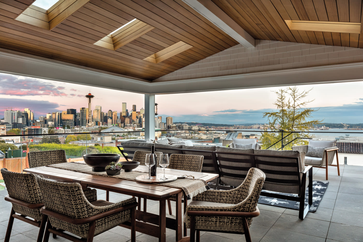 A covered deck features multiple seating areas.