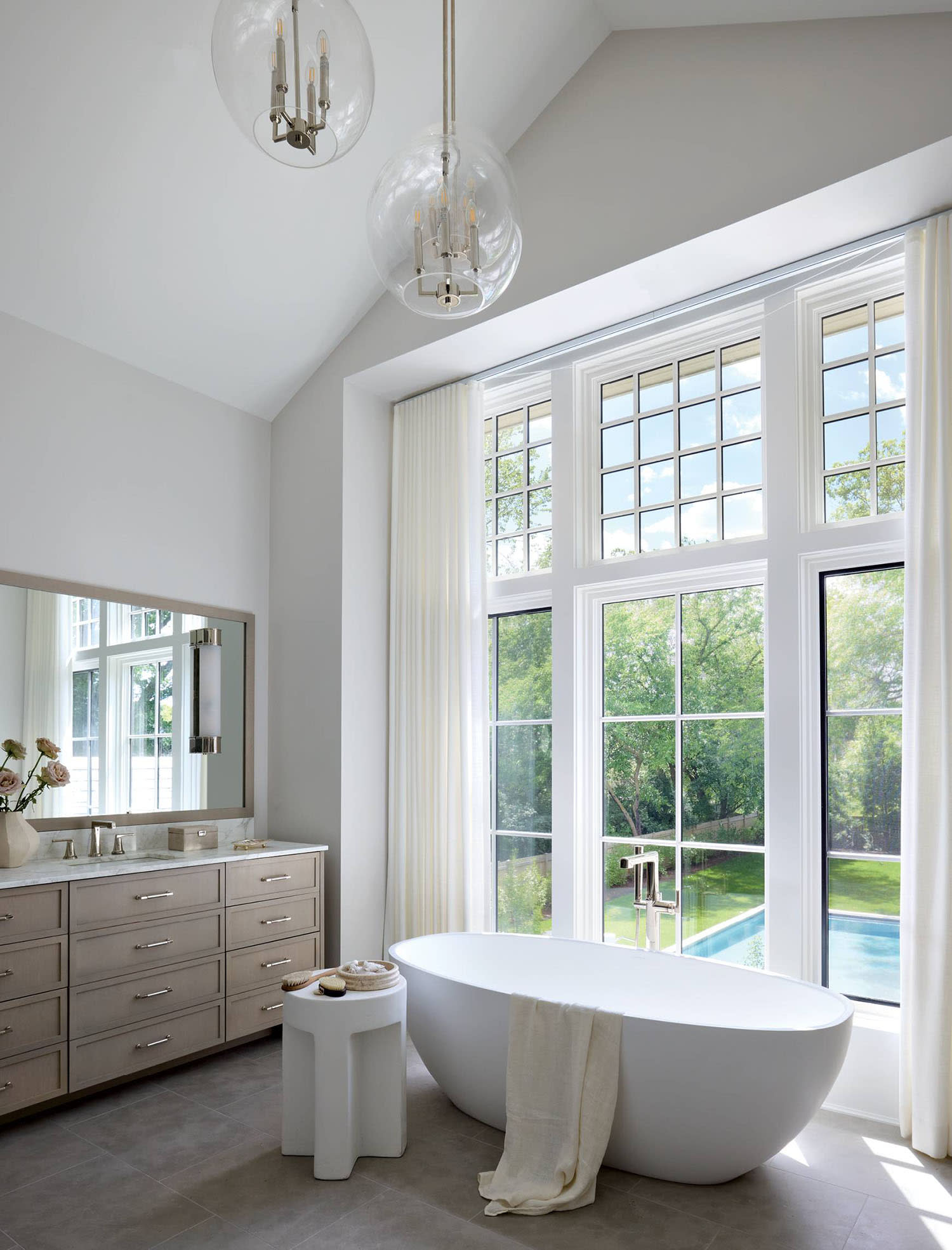 contemporary white bathroom with a freestanding tub