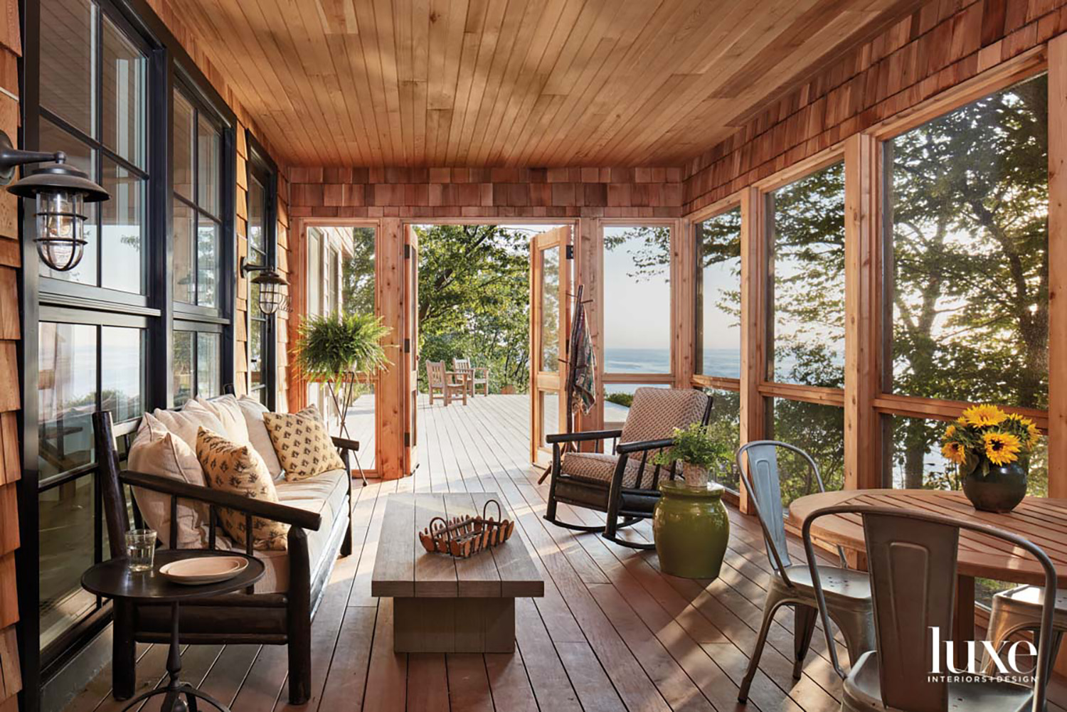 A screen porch overlooking a lake.