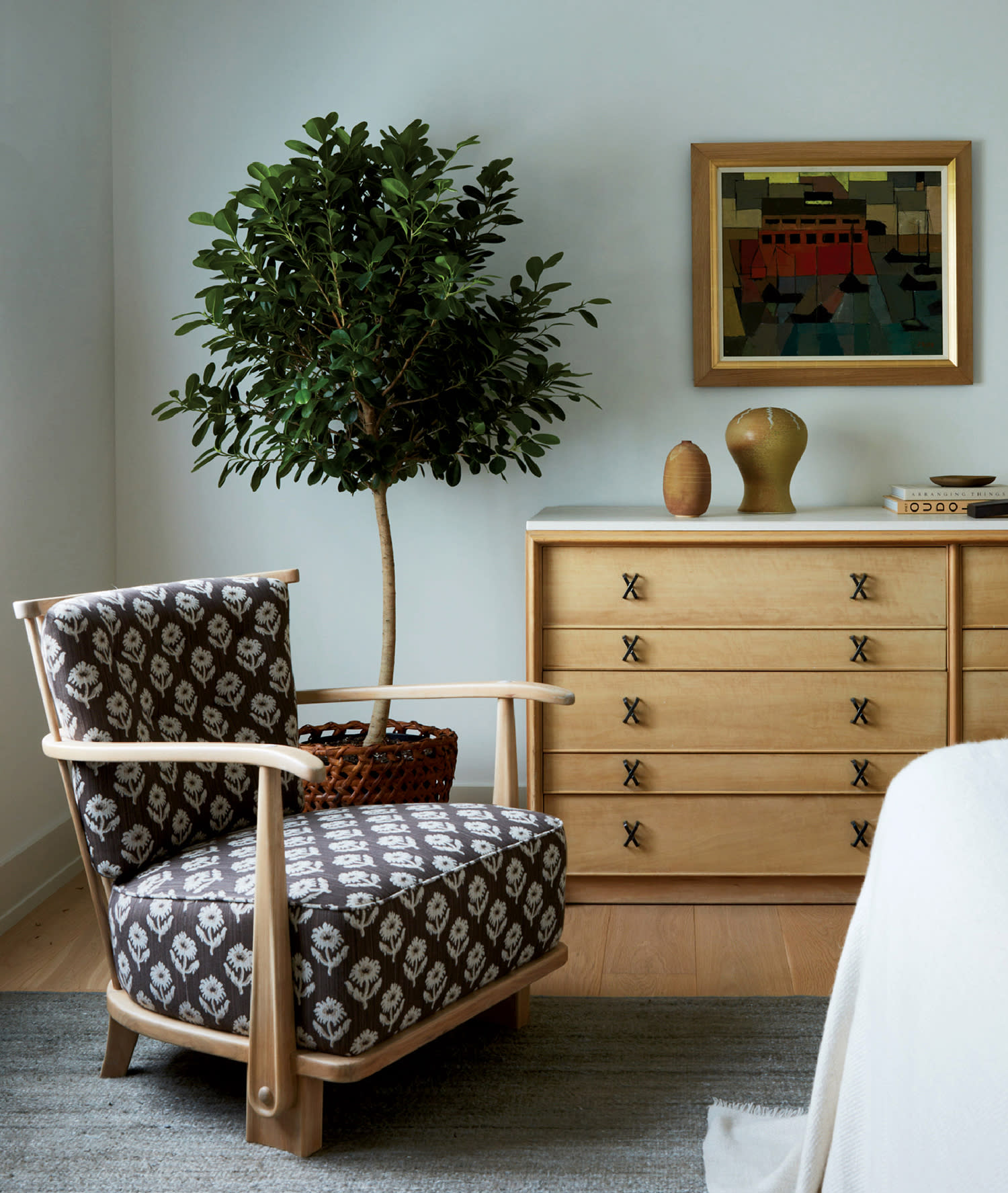seating vignette with a Scandinavian console and Danish painting