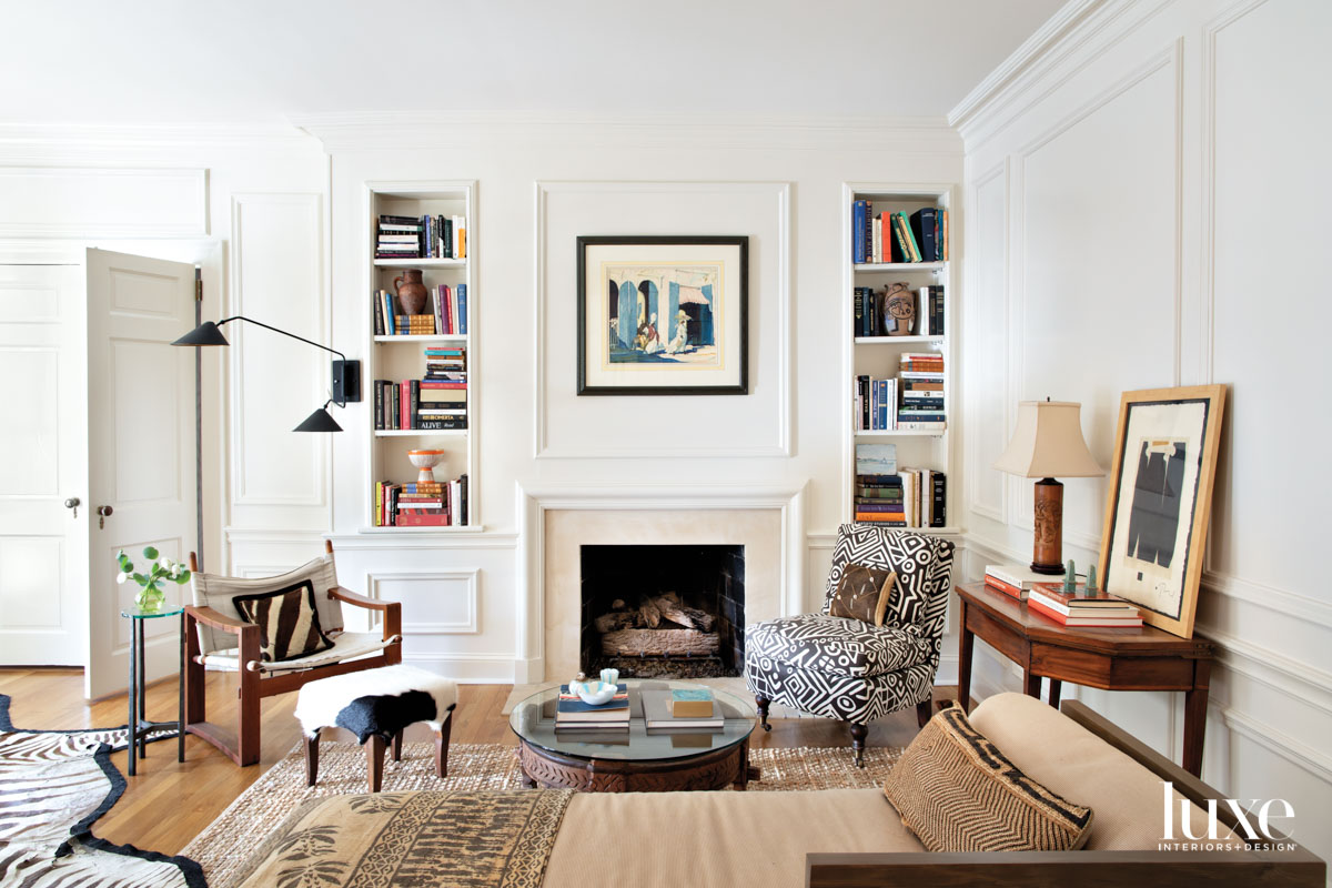 Sitting room with built-in bookshelves, fireplace and art