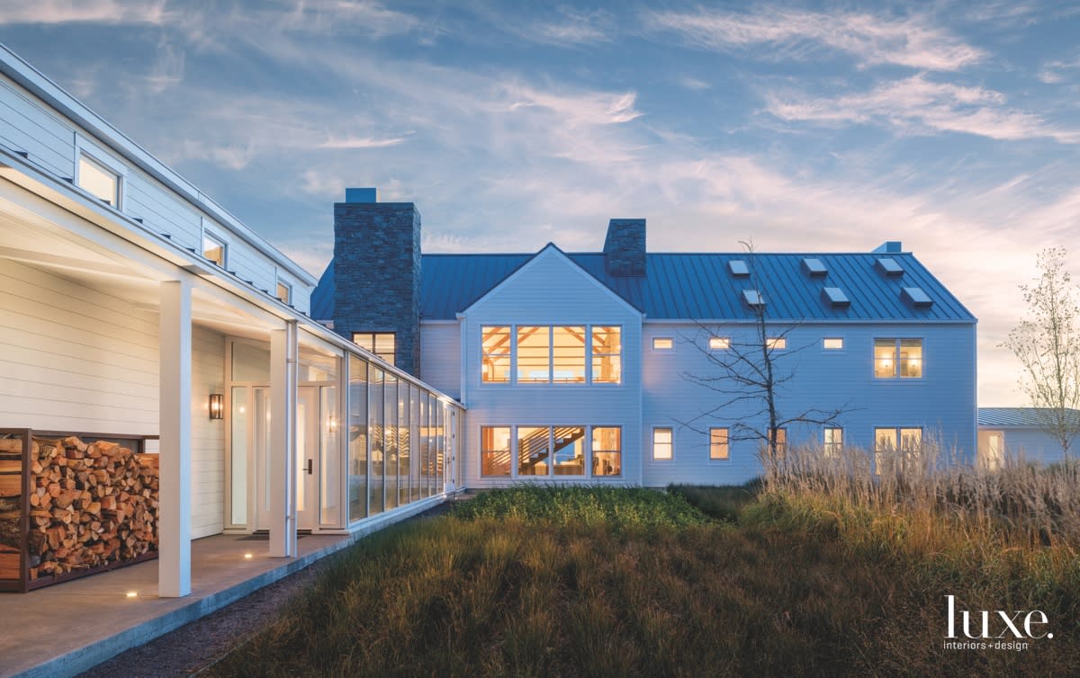 farmhouse exterior grass-filled space standing seam roof lumber