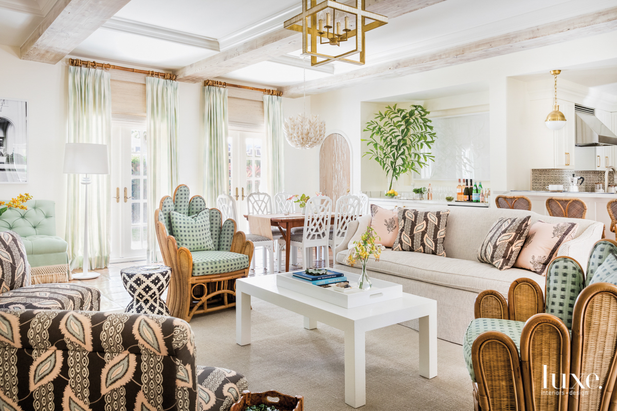 living area with pink sofa, mint armchair and white coffee table