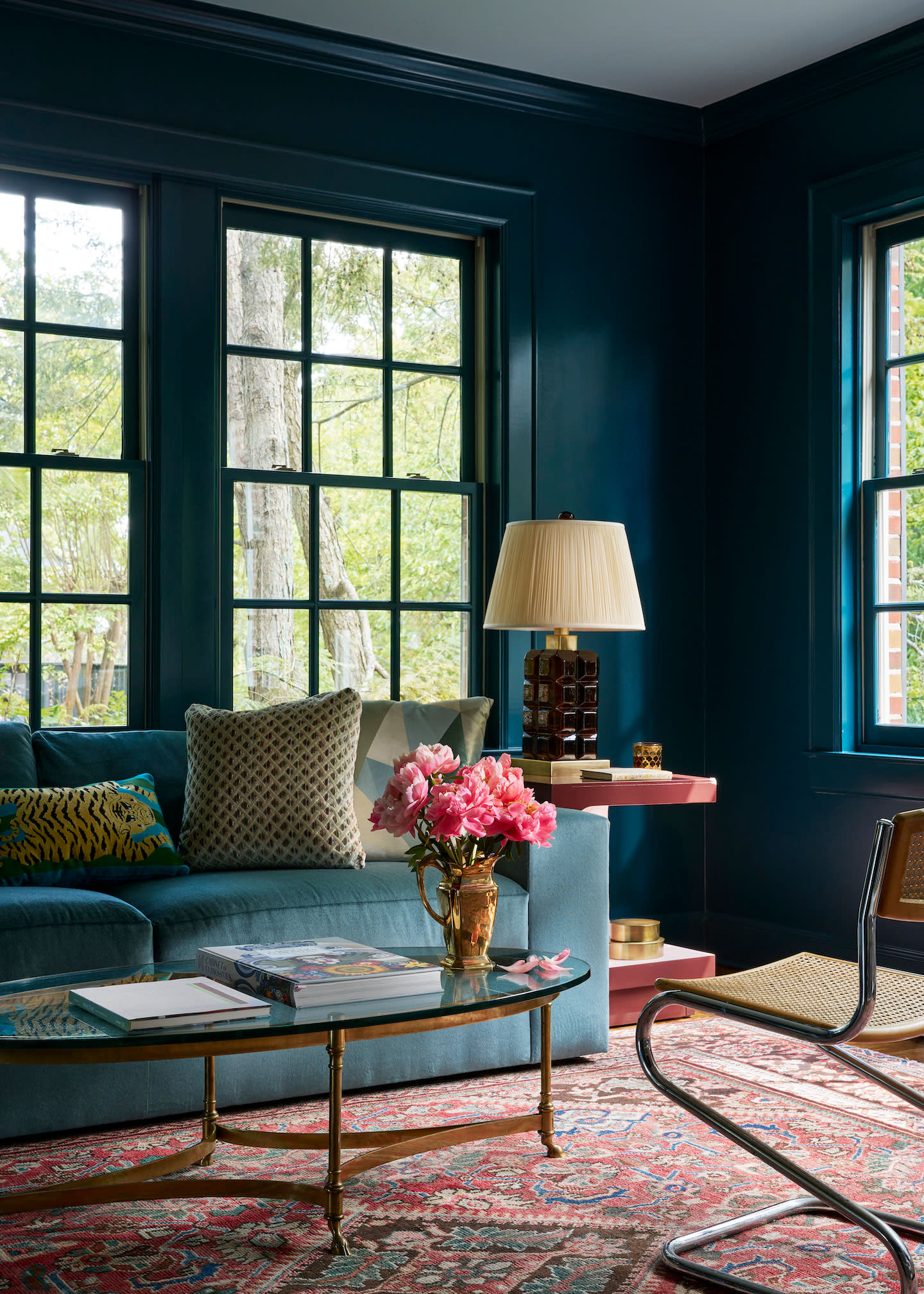 teal living room with couch in room by ryan kopet