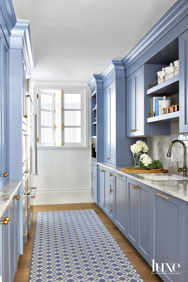 A pantry with blue cupboards.