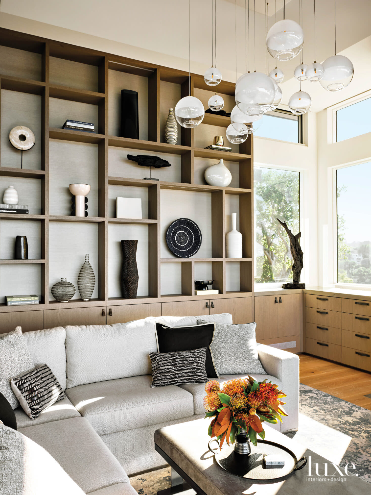 A display shelf in a living room showcases several decorative objects.