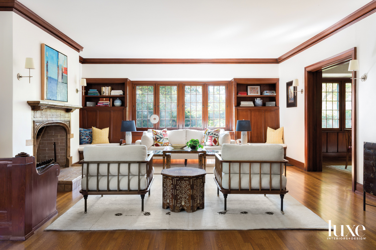 Living room with two open back lounge chairs facing a window.