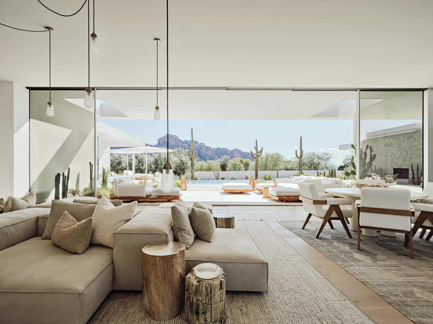 contemporary living room with petrified wood side tables and a large opening to the outdoors