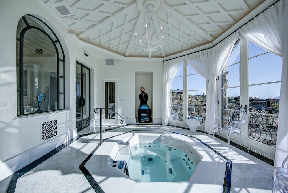 Spa tub with detailed ceiling, chandelier and mountain views from french doors