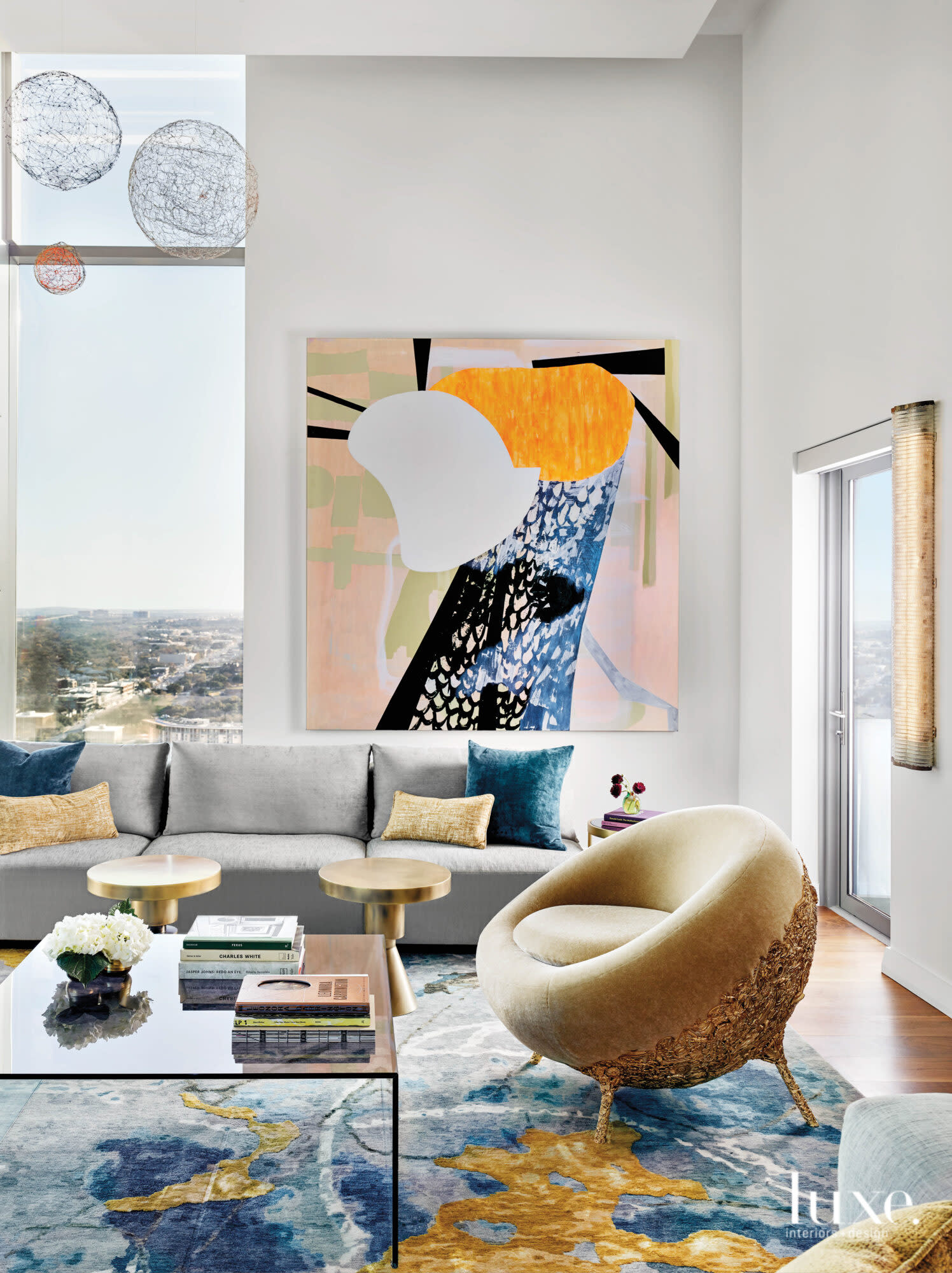 Art-filled living room with sculptural furnishings and floor-to-ceiling windows.